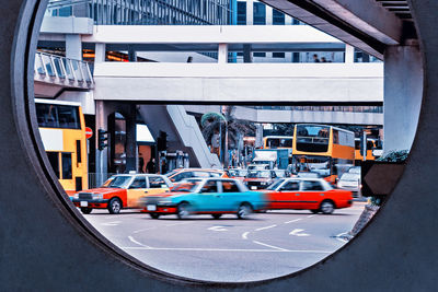 View of cars on road in city