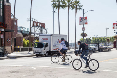 People riding bicycle on road