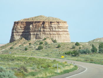 Road passing through rock formations against sky