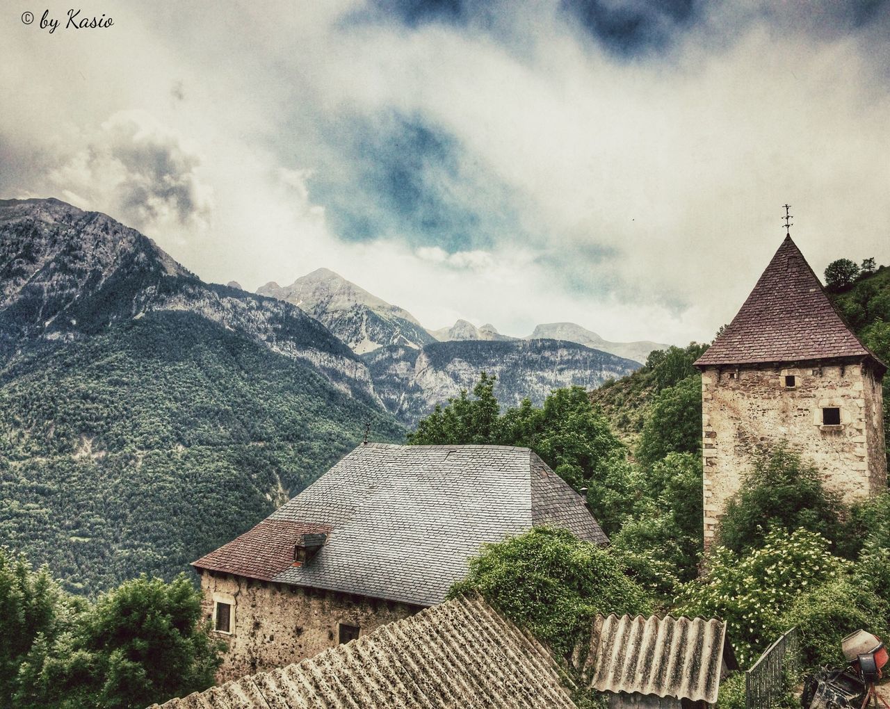 building exterior, architecture, built structure, mountain, house, sky, roof, cloud - sky, residential structure, church, mountain range, cloudy, residential building, religion, cloud, town, weather, day, place of worship