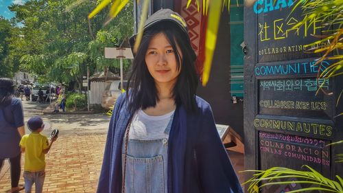 Young woman standing on street in city