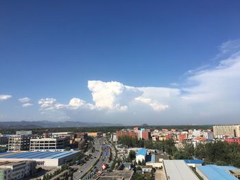 Cityscape against cloudy sky