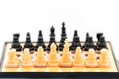 Close-up of chess board over white background