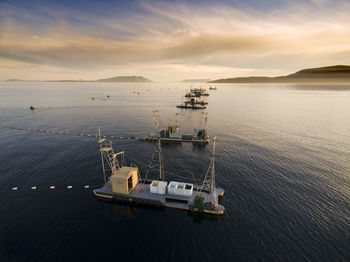 High angle view of ship in sea against cloudy sky during sunset