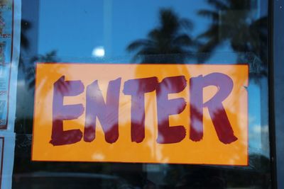 Close-up of text on glass window