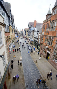 High angle view of people on street amidst buildings in city