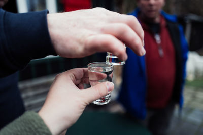 Close-up of man holding drink glass