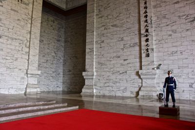 Full length of security guard standing in historic building