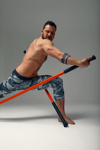 Portrait of young man exercising on floor