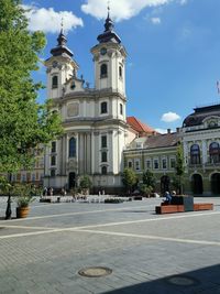 Facade of historic building against sky in city