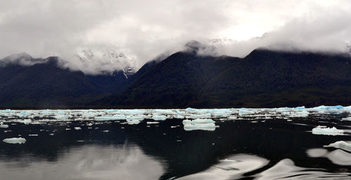 Scenic view of lake and mountains against sky