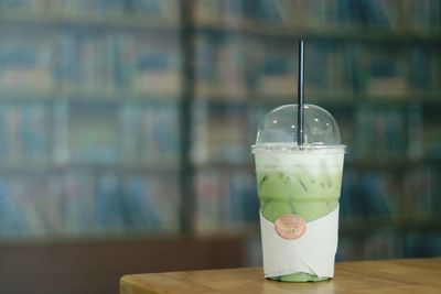 Close-up of smoothie in disposable cup on table