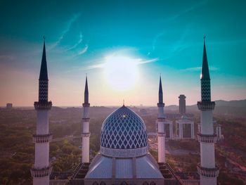 High angle view of mosque against sunny sky
