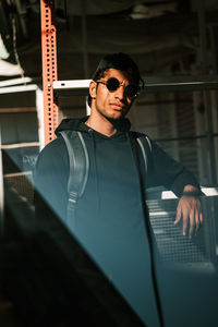 Young man leaning on metallic railing