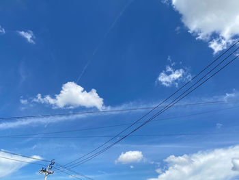 Low angle view of cables against blue sky