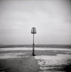 Lifeguard hut on beach against sky