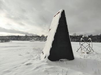 Snow covered land against sky