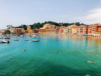 High angle view of townscape by sea against sky