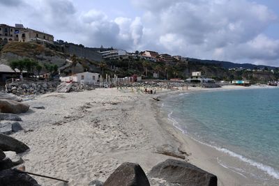 Panoramic view of beach and buildings against sky