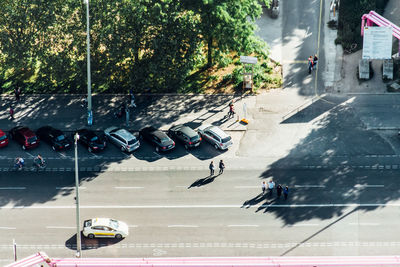 High angle view of people and cars on road