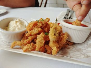 Close-up of hand holding food in plate