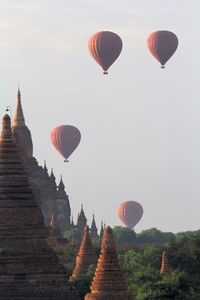 Hot air balloons flying over stupas