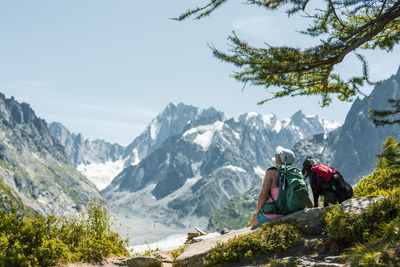 Man and mountains against sky