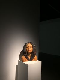 Portrait of young man standing against wall