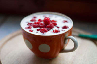 Close-up of red cup on table