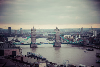 Bridge over river with city in background