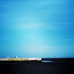 Scenic view of sea against blue sky