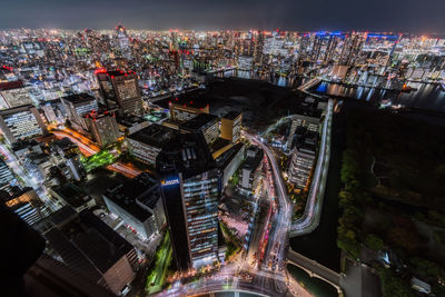 High angle view of illuminated buildings in city at night