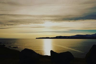 Scenic view of sea and mountains during sunset