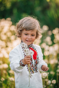 Smiling cute boy with flowers