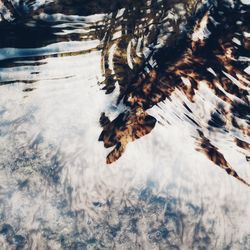 Frozen lake against sky during winter