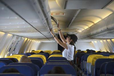 Woman standing in airplane