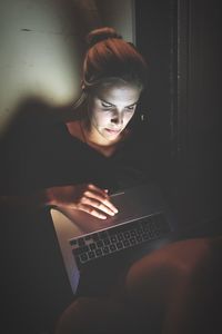 Young woman using laptop at home