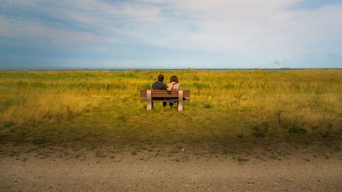 Scenic view of grassy field against sky