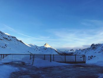 Scenic view of snowcapped mountains against blue sky