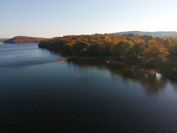 Scenic view of lake against clear sky during autumn