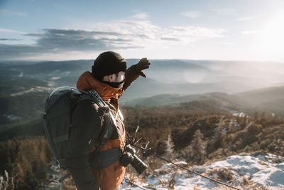 Full length of man standing on snow covered landscape