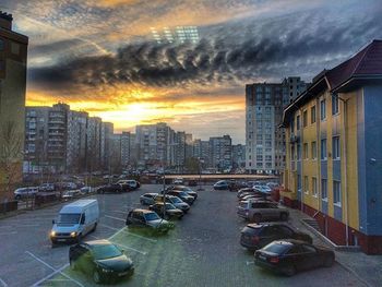 Buildings against cloudy sky at sunset