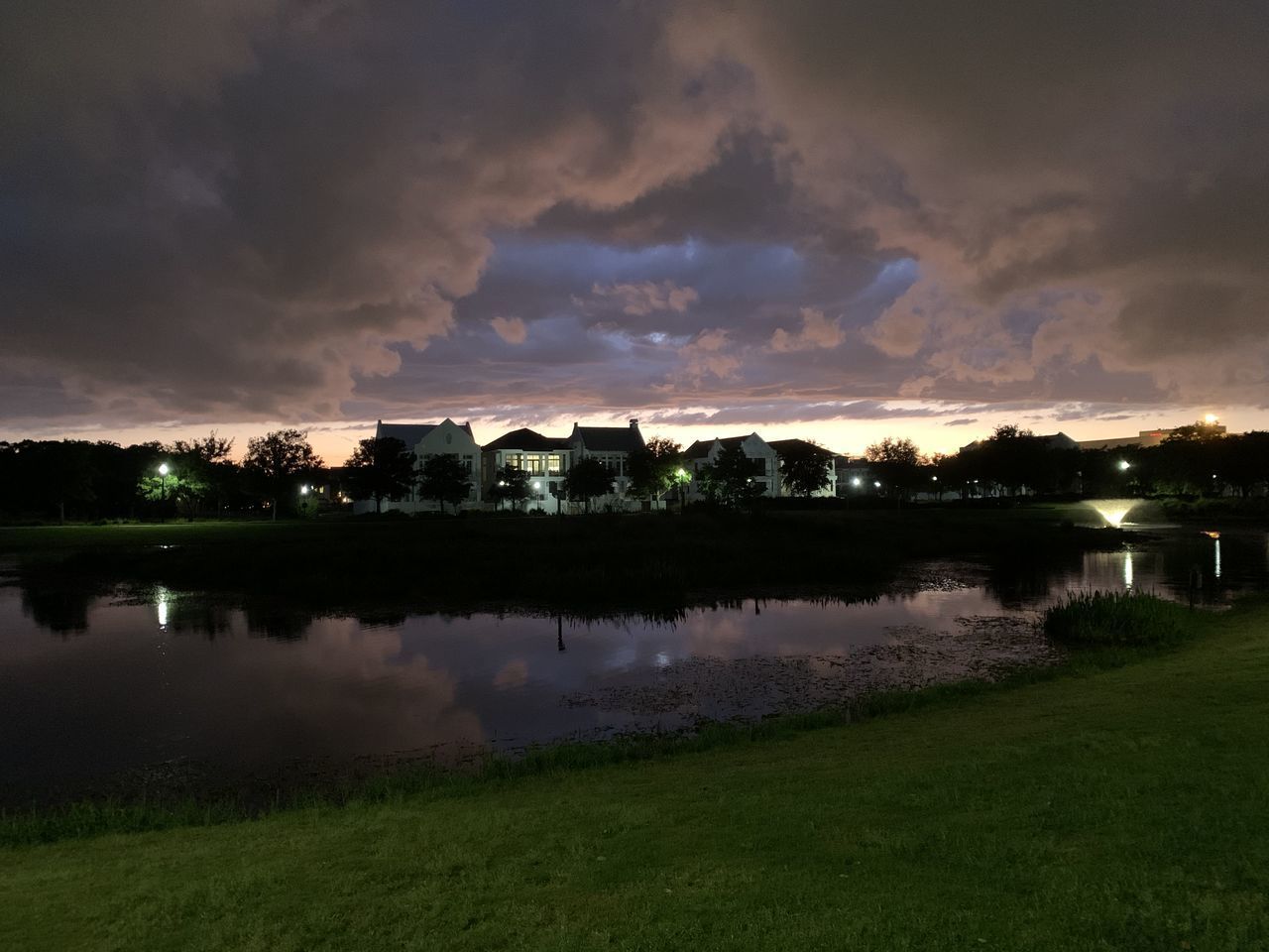 SCENIC VIEW OF LAKE BY BUILDINGS AGAINST SKY