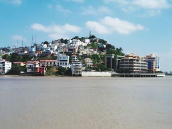 View of town against cloudy sky