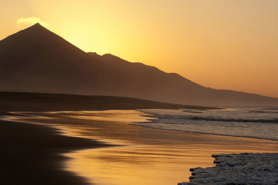 Scenic view of sea against clear sky during sunset