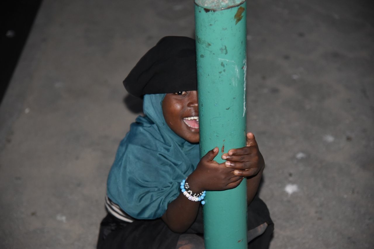 HIGH ANGLE VIEW OF BOY LOOKING DOWN