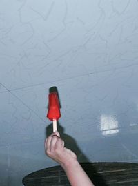 Close-up of hand holding red umbrella