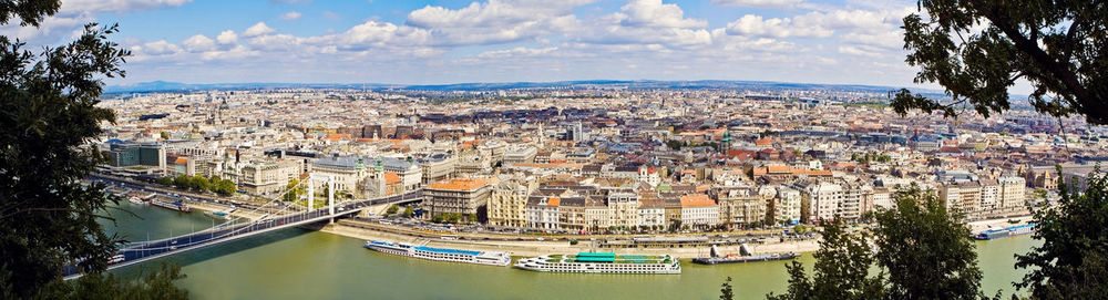 High angle view of townscape by river against sky