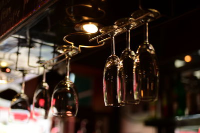 Close-up of illuminated light bulbs hanging in restaurant