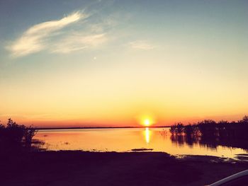 Scenic view of lake against sky during sunset